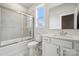 Well-lit bathroom featuring shower-tub combo, single sink vanity and bright white cabinets at 9913 Manor Vista Trl, Kannapolis, NC 28027