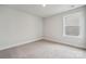 Neutral bedroom featuring a bright window, neutral carpet, and fresh paint at 9913 Manor Vista Trl, Kannapolis, NC 28027