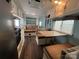Bright living area with convertible table and bed, wood flooring, and ample storage cabinets at 102 Elm St # 94, New London, NC 28127
