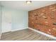 Charming bedroom with brick wall and wood-look floors at 1201 Green Oaks Ln # G, Charlotte, NC 28205