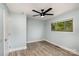 Light and airy bedroom featuring wood-look floors and a ceiling fan at 1201 Green Oaks Ln # G, Charlotte, NC 28205