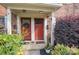 Two red doors with a wreath and potted plants at 1201 Green Oaks Ln # G, Charlotte, NC 28205