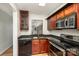 Kitchen with granite countertops and wood cabinets at 1201 Green Oaks Ln # G, Charlotte, NC 28205