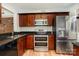 Kitchen with stainless steel appliances and dark wood cabinets at 1201 Green Oaks Ln # G, Charlotte, NC 28205