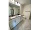 Modern bathroom with double vanity and gray flooring at 3018 Cunningham Farm Dr, Indian Trail, NC 28079