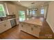 Modern kitchen with island, stainless steel appliances, and hardwood floors at 3018 Cunningham Farm Dr, Indian Trail, NC 28079