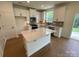 Modern kitchen with island, stainless steel appliances, and hardwood floors at 3018 Cunningham Farm Dr, Indian Trail, NC 28079