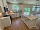 Modern kitchen with island, stainless steel appliances, and hardwood floors at 3018 Cunningham Farm Dr, Indian Trail, NC 28079