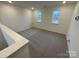 Upstairs loft area featuring neutral carpet, recessed lighting, and ample natural light from two windows at 3018 Cunningham Farm Dr, Indian Trail, NC 28079