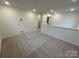 Upstairs loft area featuring neutral carpet, recessed lighting, and electrical outlets at 3018 Cunningham Farm Dr, Indian Trail, NC 28079