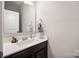 Powder room with single sink vanity, large mirror, and great lighting at 3020 Pinehills Way, Mount Holly, NC 28120