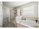 Beautiful bathroom with a tiled shower, a soaking tub, and a large window at 3020 Pinehills Way, Mount Holly, NC 28120