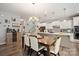 Open dining area next to the kitchen with pendant lights and access to the living room at 3020 Pinehills Way, Mount Holly, NC 28120