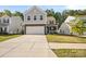 Charming two-story home with stone accents, a two-car garage, and a well-manicured front lawn in a neighborhood at 3020 Pinehills Way, Mount Holly, NC 28120