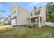 Two-story home with stone accents, a two-car garage, and a well-manicured front lawn in a neighborhood at 3020 Pinehills Way, Mount Holly, NC 28120