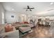 Open concept living room with view to the kitchen, dining area, and staircase with lots of natural light at 3020 Pinehills Way, Mount Holly, NC 28120