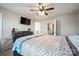 Spacious main bedroom featuring a ceiling fan, TV, walk-in closet, and ensuite bathroom at 3020 Pinehills Way, Mount Holly, NC 28120