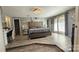 Large main bedroom with plush bed, hardwood floors, and ensuite bathroom at 6001 Long Pine Dr, Charlotte, NC 28227