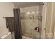 Updated shower with marble and stone tile and built-in seat at 6001 Long Pine Dr, Charlotte, NC 28227