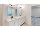 Modern bathroom featuring double sinks, white cabinetry, and contemporary lighting at 10132 Whitaker Pointe Dr, Huntersville, NC 28078