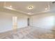 Spacious bedroom featuring tray ceilings, recessed lighting, and carpet flooring at 10132 Whitaker Pointe Dr, Huntersville, NC 28078