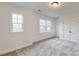 Bright bedroom with neutral carpet, natural light from windows, and a closet at 10132 Whitaker Pointe Dr, Huntersville, NC 28078