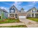 Charming brick two-story home featuring a two-car garage, well-maintained lawn and manicured landscaping at 10132 Whitaker Pointe Dr, Huntersville, NC 28078