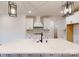 Bright kitchen with a large center island, modern pendant lighting, and white cabinets and countertops at 10132 Whitaker Pointe Dr, Huntersville, NC 28078