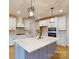 Beautiful kitchen with a large island, stainless steel appliances, white cabinets, and stylish pendant lighting at 10132 Whitaker Pointe Dr, Huntersville, NC 28078