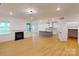 Open-concept living room and kitchen with island and fireplace, perfect for entertaining at 10132 Whitaker Pointe Dr, Huntersville, NC 28078