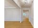 Inviting open-concept living room showcasing a sleek design with wood floors, paneling, and natural light at 10132 Whitaker Pointe Dr, Huntersville, NC 28078