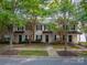 Front view of townhome with tree-lined street at 11006 Will Knox Rd, Cornelius, NC 28031