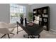 Virtually staged home office with a large desk and built-in shelving at 14307 San Paolo Ln # 5102, Charlotte, NC 28277