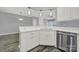 White kitchen cabinets and quartz countertops, stainless steel dishwasher at 14307 San Paolo Ln # 5102, Charlotte, NC 28277