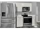 Stainless steel refrigerator and range with white cabinets at 14307 San Paolo Ln # 5102, Charlotte, NC 28277
