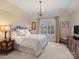 Charming bedroom with a comfortable bed and plenty of natural light at 9029 Pine Laurel Dr, Weddington, NC 28104