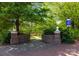 Entrance to Dale Earnhardt Tribute Plaza, featuring brick pillars and lush landscaping at 9921 Manor Vista Trl, Kannapolis, NC 28027