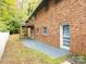 An exterior view of the backyard, featuring a brick house, patio and wooden deck at 110 Mimosa Rd, Statesville, NC 28677