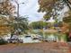 Picturesque lake view featuring boats docked and homes nestled amidst colorful fall foliage at 110 Mimosa Rd, Statesville, NC 28677