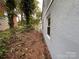 Exterior shot of the backyard showing the exterior wall of the house and landscaping at 131 Glendale Se Ave, Concord, NC 28025
