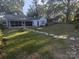 Spacious, grassy backyard with stone path leading to a screened-in porch at 131 Glendale Se Ave, Concord, NC 28025