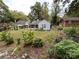 View of the backyard and exterior of the home with a screened-in porch and lush garden area at 131 Glendale Se Ave, Concord, NC 28025