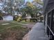 Spacious backyard featuring a stone patio, outbuildings, and lush greenery, ideal for outdoor living at 131 Glendale Se Ave, Concord, NC 28025