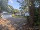 Gravel backyard with a large shed and surrounding trees with natural light at 131 Glendale Se Ave, Concord, NC 28025