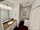 Bright bathroom features vanity with granite counters, tub/shower, and linen closet at 131 Glendale Se Ave, Concord, NC 28025