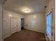 Bright bedroom featuring carpeted floors, two windows, and a closet at 131 Glendale Se Ave, Concord, NC 28025