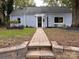 Inviting home with a well-manicured lawn and charming brick walkway at 131 Glendale Se Ave, Concord, NC 28025