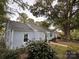 Charming single-story home with light blue siding, mature trees, and landscaped front yard at 131 Glendale Se Ave, Concord, NC 28025