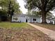Charming home with a brick path leading to the front door and surrounded by mature trees at 131 Glendale Se Ave, Concord, NC 28025