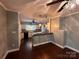 Kitchen offers white cabinets and backsplash, with open view to the dining area at 131 Glendale Se Ave, Concord, NC 28025